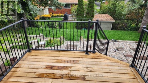 A wooden deck with a metal railing.