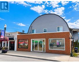 A building with a grey roof and a sign that says "REALTOR" on it.