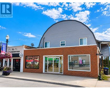 A building with a grey roof and a sign that says "REALTOR" on it.