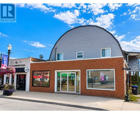 A building with a grey roof and a sign that says "REALTOR" on it.