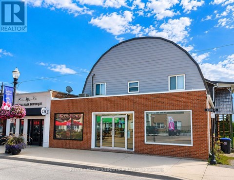 A building with a grey roof and a sign that says "REALTOR" on it.