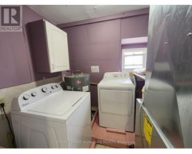 A white washing machine and dryer in a small room.