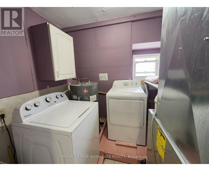 A white washing machine and dryer in a small room.