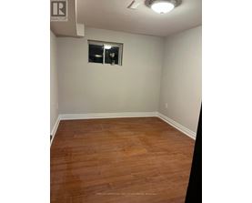 A room with a wooden floor and a window.