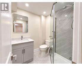 A bathroom with a sink, toilet, and shower.