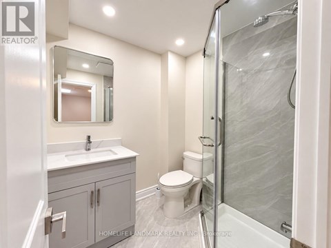 A bathroom with a sink, toilet, and shower.