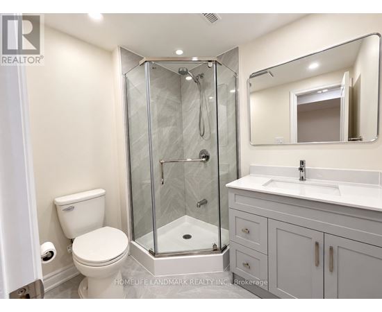 A bathroom with a toilet, sink, and shower.