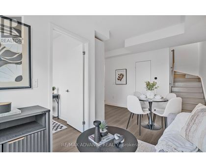 A living room with a dining table and chairs.