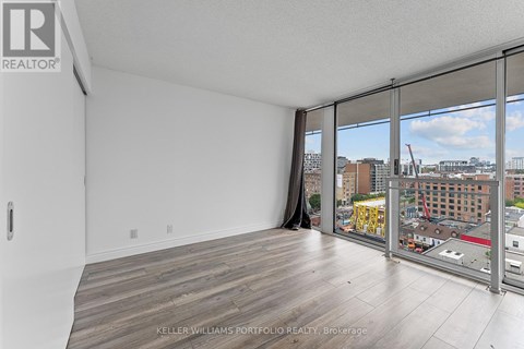A room with a view of the cityscape through the windows.
