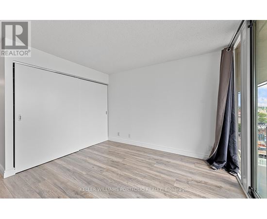 A room with a sliding door and a wooden floor.