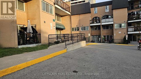 A brokerage office for CITYSCAPE REAL ESTATE LTD. is shown in front of a building.