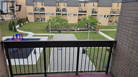 A balcony view of a playground and apartment complex.