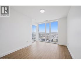 A spacious room with a view of the city through large windows.