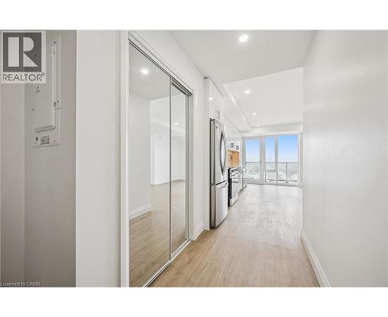 A modern kitchen with a refrigerator, sink, and sliding glass doors.