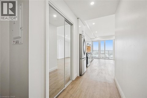 A modern kitchen with a refrigerator, sink, and sliding glass doors.