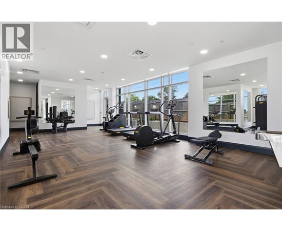 A gym with a variety of equipment including treadmills, weights, and exercise machines.