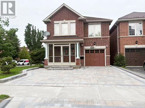 A brick house with a garage door is for sale.