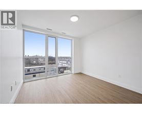 A large empty room with a view of the city through the windows.