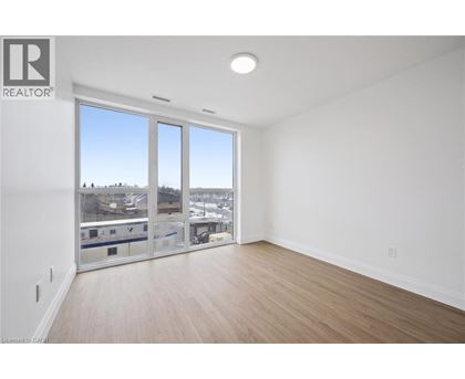 A large empty room with a view of the city through the windows.