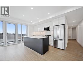A modern kitchen with a large island and stainless steel appliances.