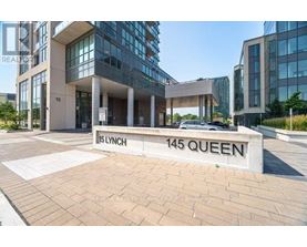 The image shows a building entrance with a sign that reads "15 LYNCH 145 QUEEN".