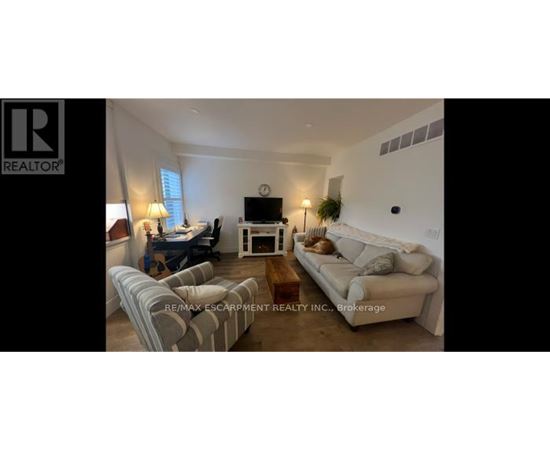 A living room with a couch, chair, and coffee table.