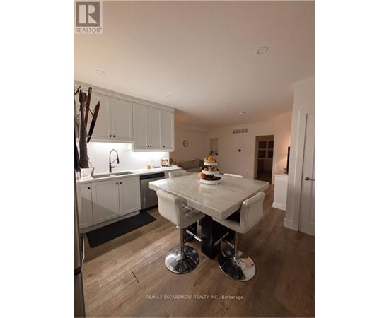 A modern kitchen with a dining table and chairs.