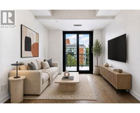 A modern living room with a large window and a flat screen TV mounted on the wall.