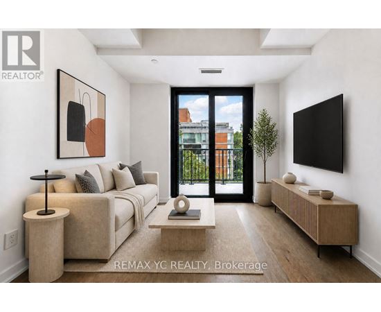 A modern living room with a large window and a flat screen TV mounted on the wall.