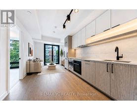 A modern kitchen with white cabinets and a large island.