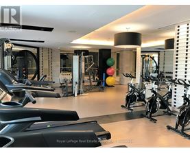 A gym with a variety of equipment including treadmills, stationary bikes, and weight machines.