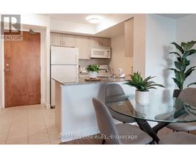 A modern kitchen with a glass table and chairs.