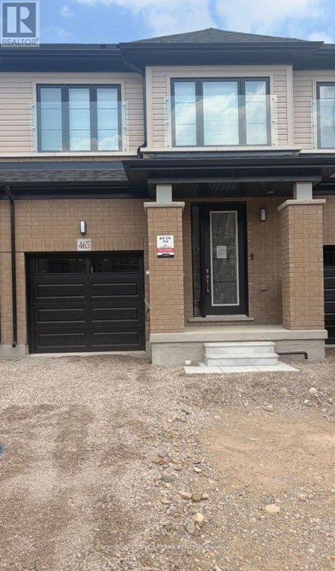 A house with a black garage door and a white door.