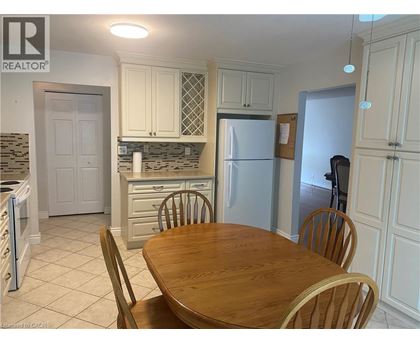 A kitchen with a table and chairs in the foreground.