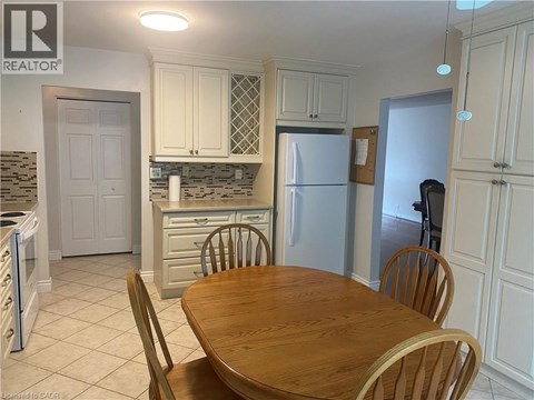 A kitchen with a table and chairs in the foreground.