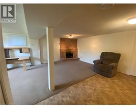 A living room with a fireplace and a chair.