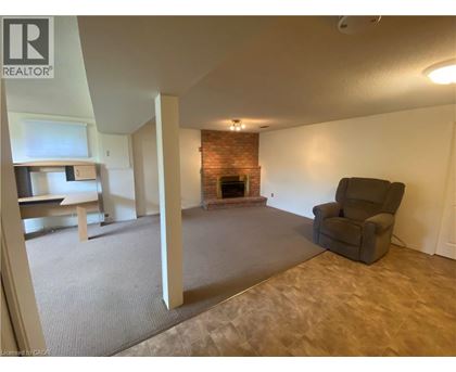A living room with a fireplace and a chair.