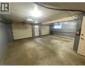 A spacious garage with a concrete floor and white walls.