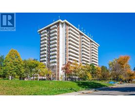 A tall building with a grassy area in front of it.