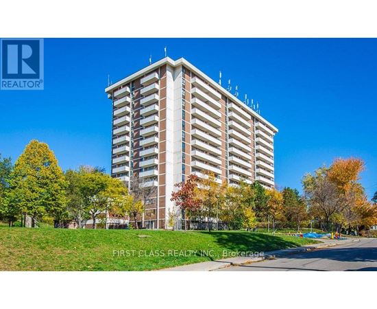 A tall building with a grassy area in front of it.