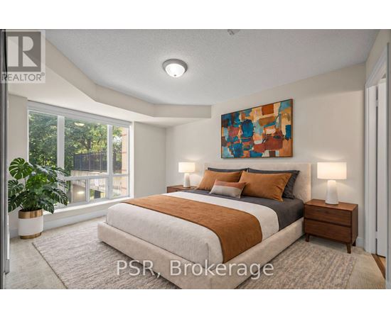 A bedroom with a large bed and a painting on the wall.