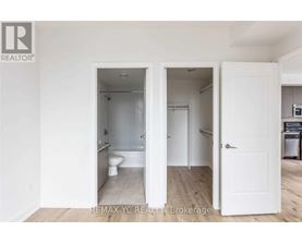 A white bathroom with a toilet and sink is shown in the image.