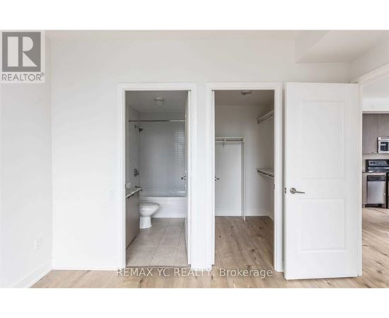 A white bathroom with a toilet and sink is shown in the image.