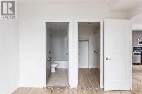A white bathroom with a toilet and sink is shown in the image.