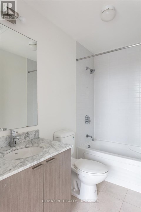 A white toilet sits next to a sink in a bathroom.