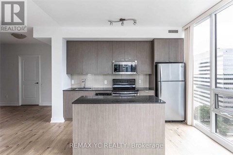 A modern kitchen with a wooden island and stainless steel appliances.