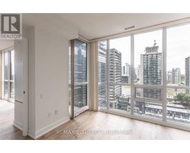 A room with a view of the cityscape through large windows.