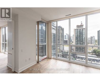 A room with a view of the cityscape through large windows.