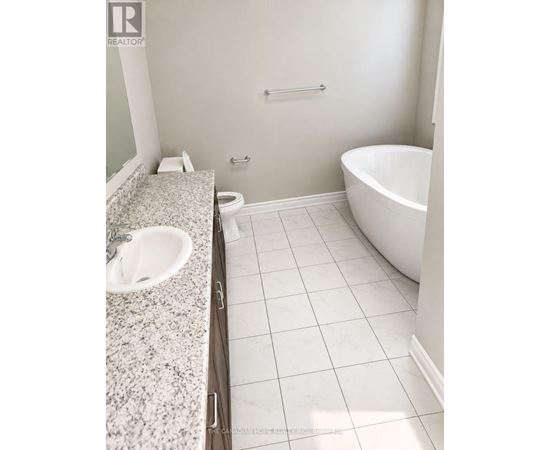 A white bathroom with a sink, toilet and bathtub.