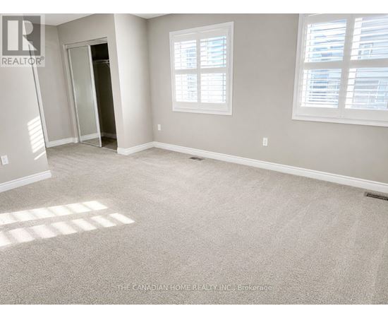 A room with a carpeted floor and a doorway leading to another room.